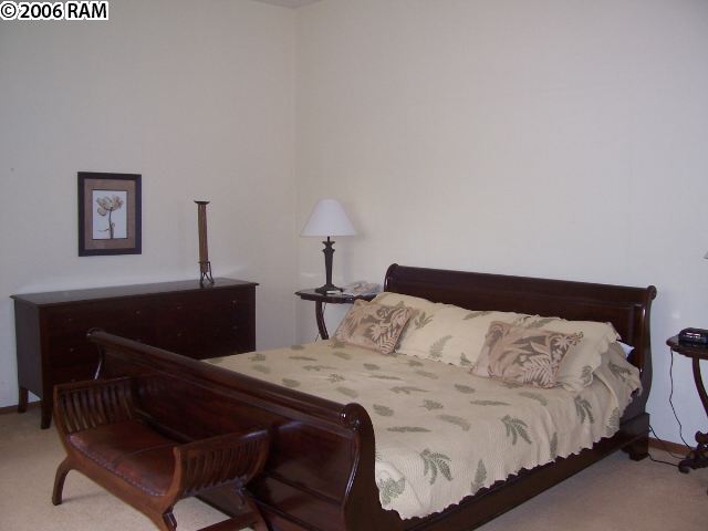 100 Ridge Road, Unit 1721 Lahaina, HI 96761 - Photo 13 of 17 a bedroom with a bed and a lamp on table
