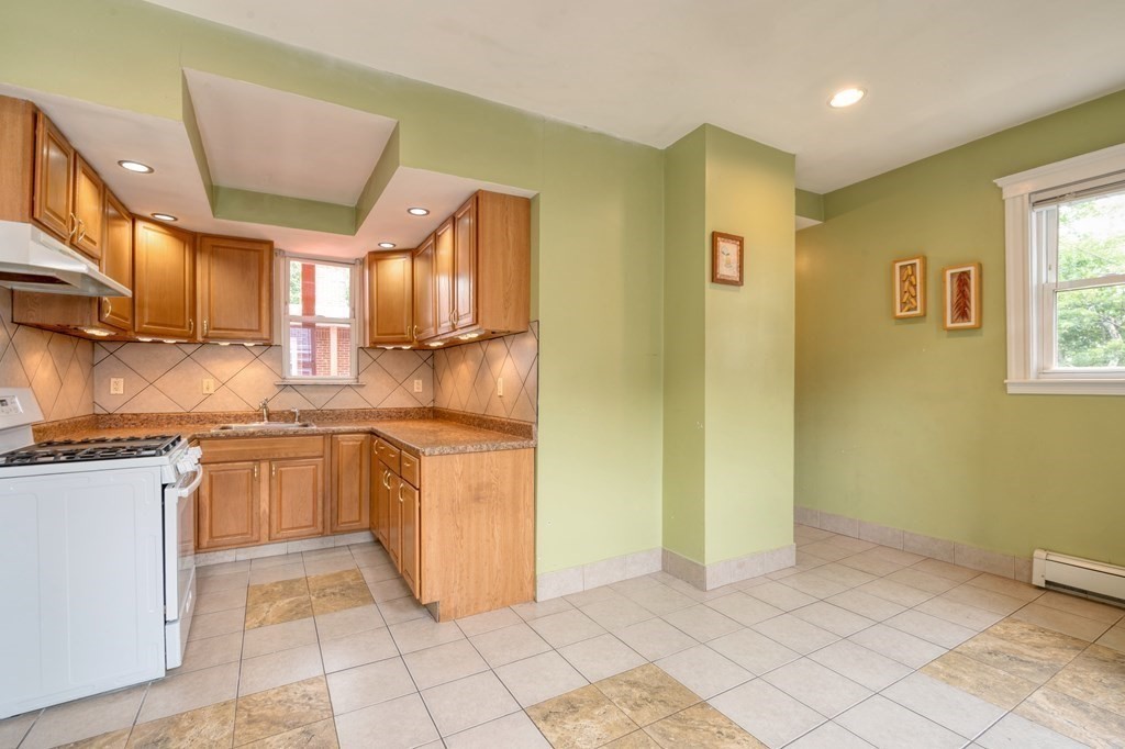 43 Ormond Street Boston, MA 02126 - Photo 17 of 30 a kitchen with stainless steel appliances granite countertop a refrigerator and a stove top oven