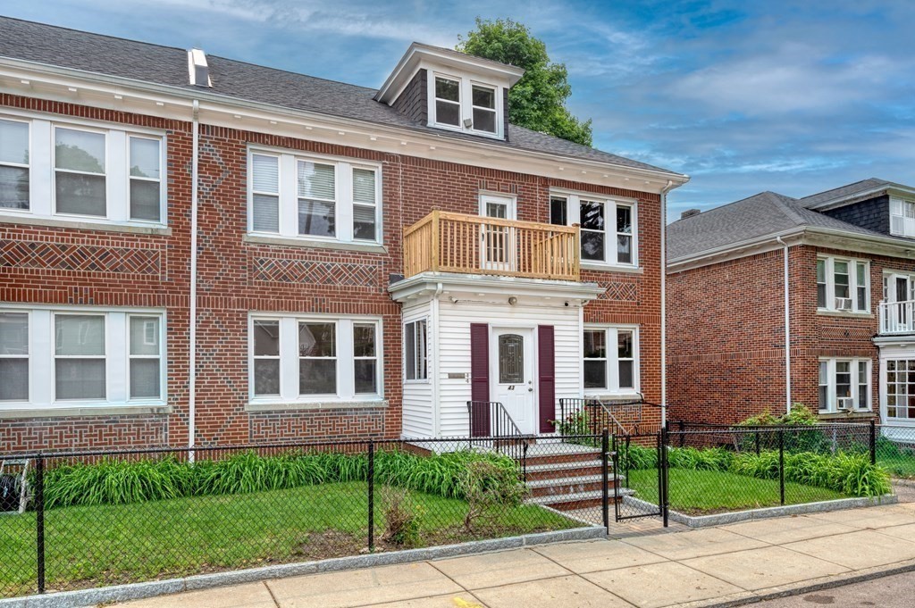 43 Ormond Street Boston, MA 02126 - Photo 28 of 30 front view of a brick house with a yard