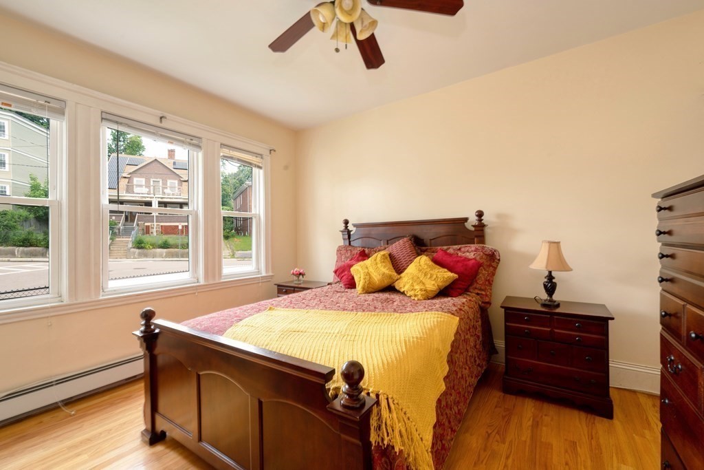 43 Ormond Street Boston, MA 02126 - Photo 5 of 30 a bedroom with a bed and wooden floor