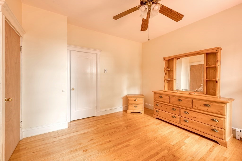 43 Ormond Street Boston, MA 02126 - Photo 6 of 30 a bedroom with a bed and cabinets
