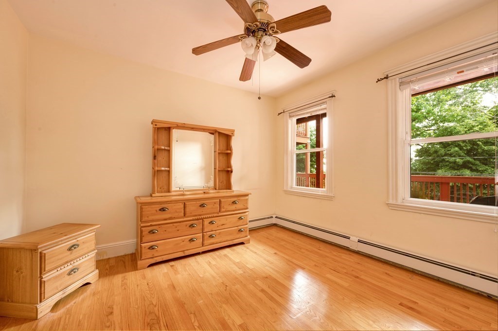43 Ormond Street Boston, MA 02126 - Photo 7 of 30 a spacious bedroom with a bed and a window