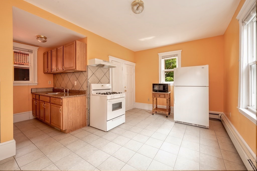 43 Ormond Street Boston, MA 02126 - Photo 9 of 30 a kitchen with white cabinets and white appliances