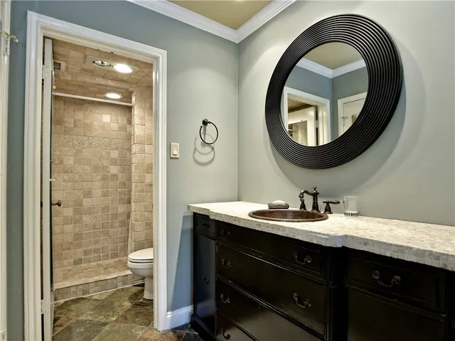 a bathroom with a toilet a sink and mirror
