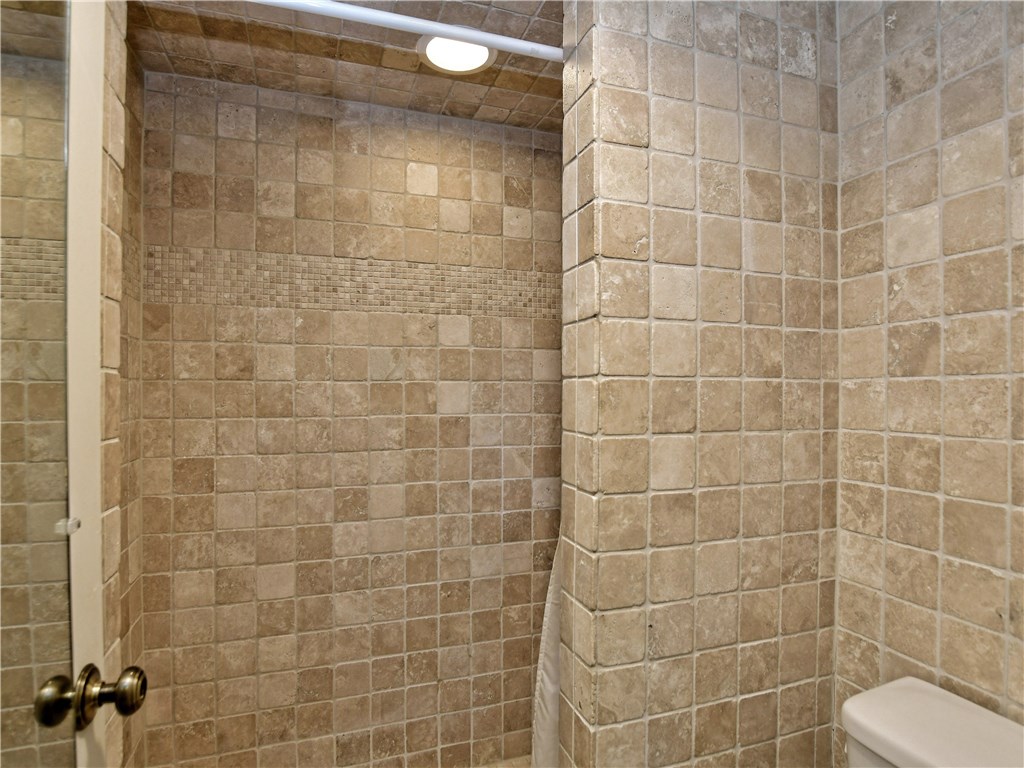 120 World Of Tennis Square, Unit 118C Lakeway, TX 78738 - Photo 12 of 29 a bathroom with a shower