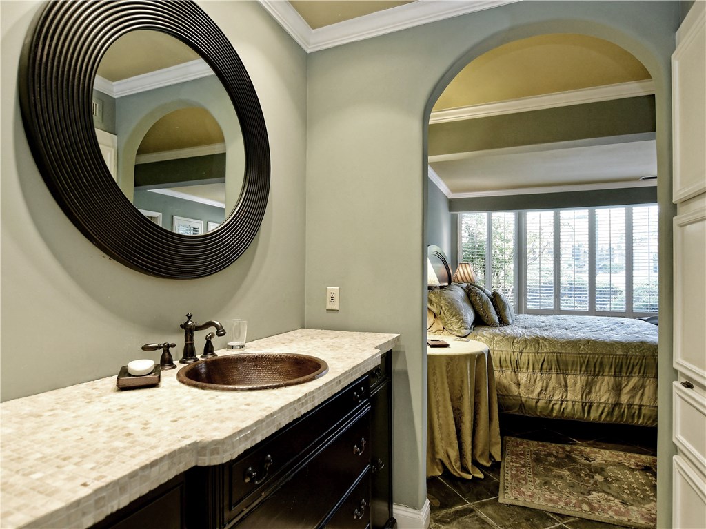 120 World Of Tennis Square, Unit 118C Lakeway, TX 78738 - Photo 13 of 29 a bedroom with a bed and a mirror