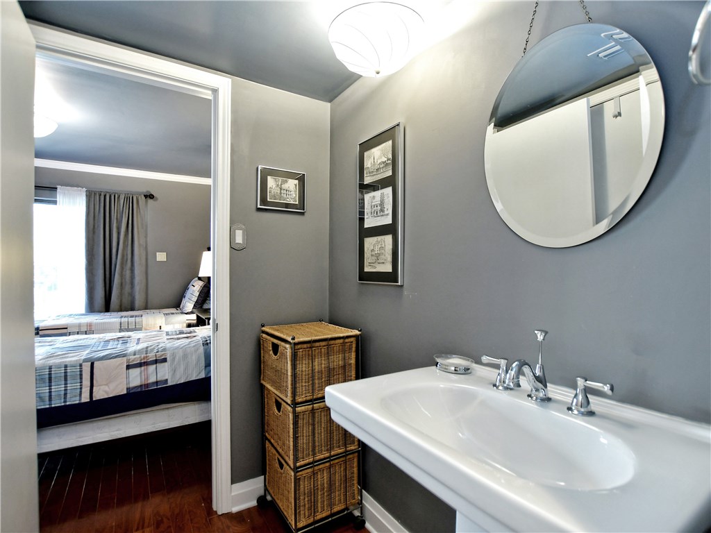 120 World Of Tennis Square, Unit 118C Lakeway, TX 78738 - Photo 15 of 29 a bathroom with a double vanity sink and a mirror