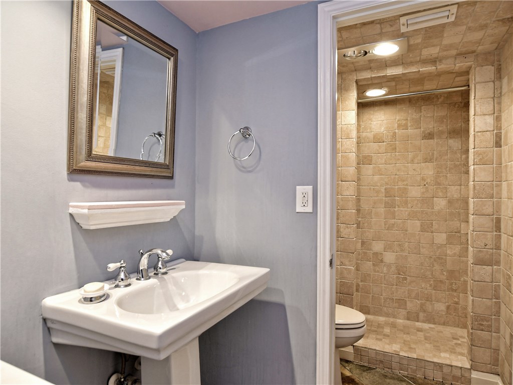 120 World Of Tennis Square, Unit 118C Lakeway, TX 78738 - Photo 19 of 29 a bathroom with a sink a toilet and shower