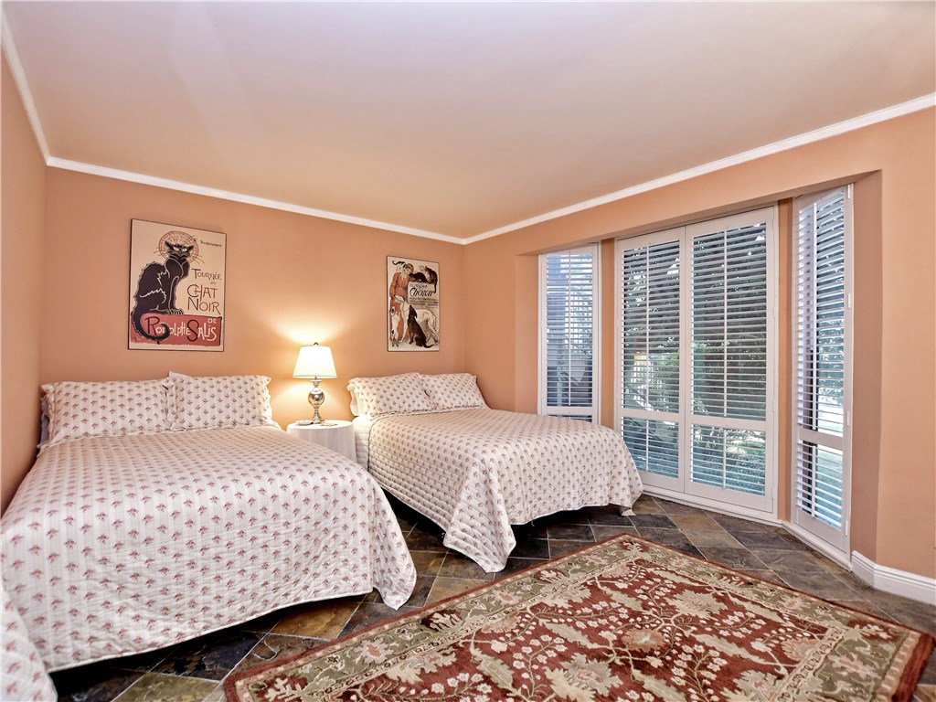 120 World Of Tennis Square, Unit 118C Lakeway, TX 78738 - Photo 20 of 29 a bedroom with two beds and a window with outer view