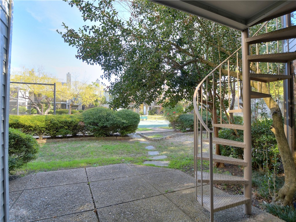 120 World Of Tennis Square, Unit 118C Lakeway, TX 78738 - Photo 22 of 29 a front view of a house with a yard