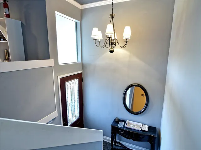 wooden floor with a potted plant and a mirror