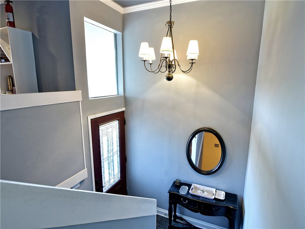 120 World Of Tennis Square, Unit 118C Lakeway, TX 78738 - Photo 3 of 29 wooden floor with a potted plant and a mirror