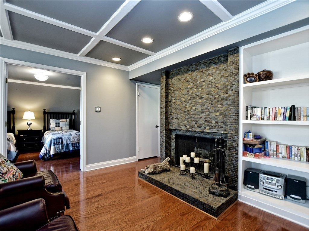 120 World Of Tennis Square, Unit 118C Lakeway, TX 78738 - Photo 6 of 29 a living room with furniture and a fireplace