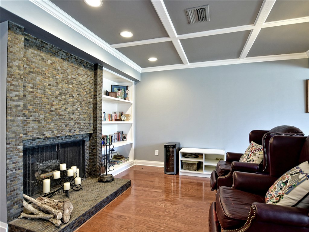 120 World Of Tennis Square, Unit 118C Lakeway, TX 78738 - Photo 7 of 29 a living room with furniture and a fireplace