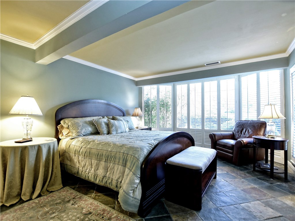 120 World Of Tennis Square, Unit 118C Lakeway, TX 78738 - Photo 10 of 29 a bedroom with a bed a table chair and a large window