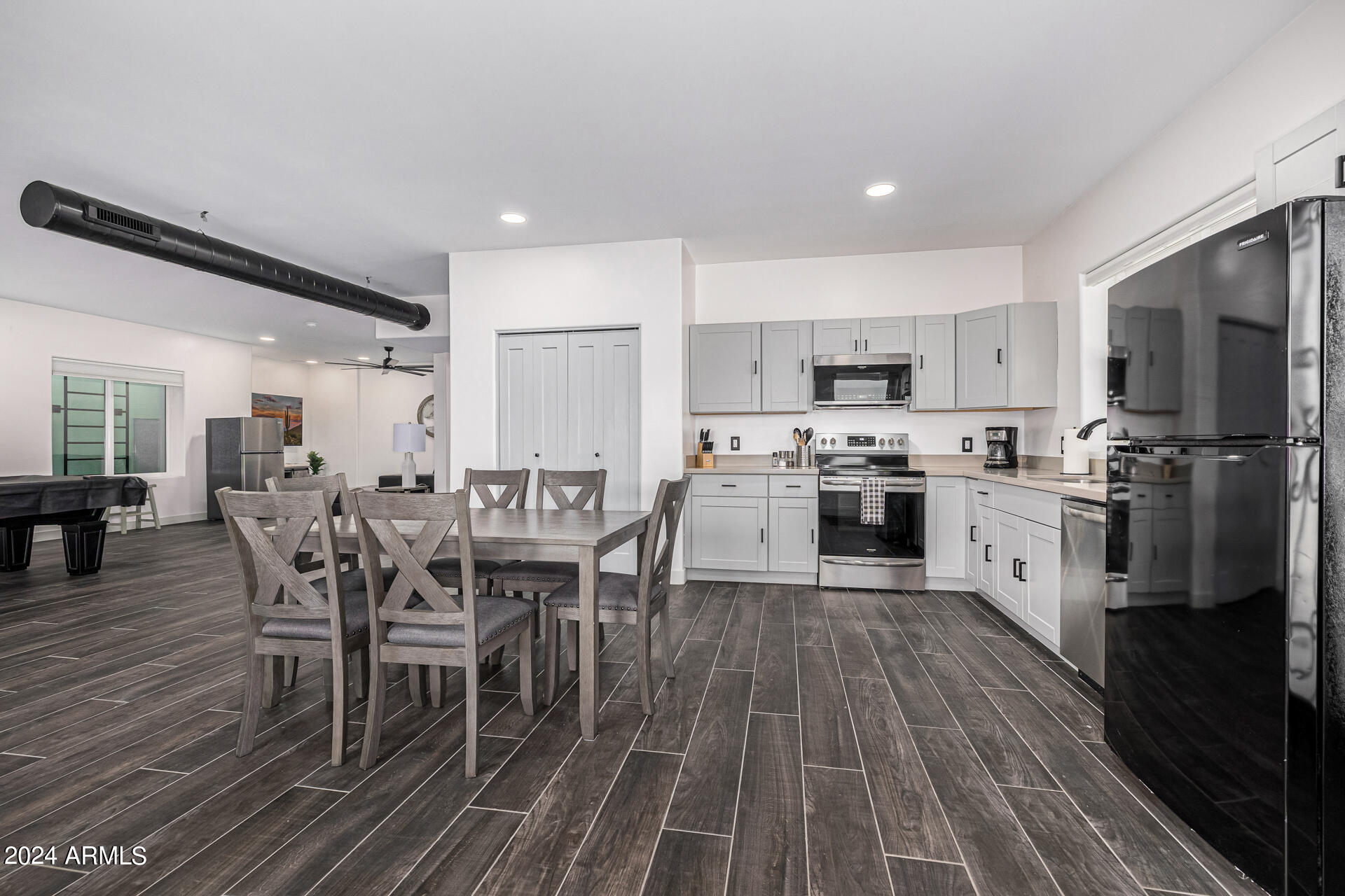 1829 West Cloud Road Phoenix, AZ 85086 - Photo 71 of 137 a kitchen with stainless steel appliances a stove a sink a oven a dining table and chairs