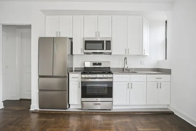 a kitchen with stainless steel appliances a refrigerator and a stove top oven
