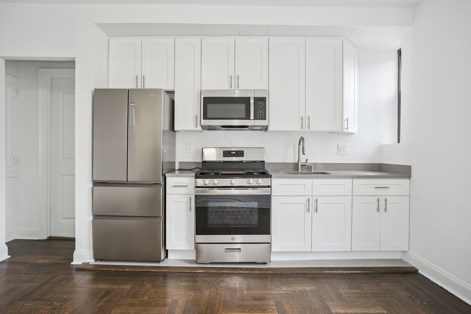 80 Winthrop Street, Unit U3 Brooklyn, NY 11225 - Photo 3 of 8 a kitchen with granite countertop white cabinets and stainless steel appliances