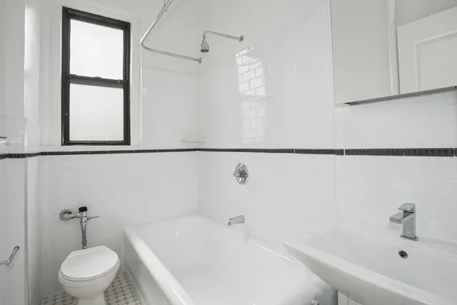 a view of an empty room with wooden floor and closet