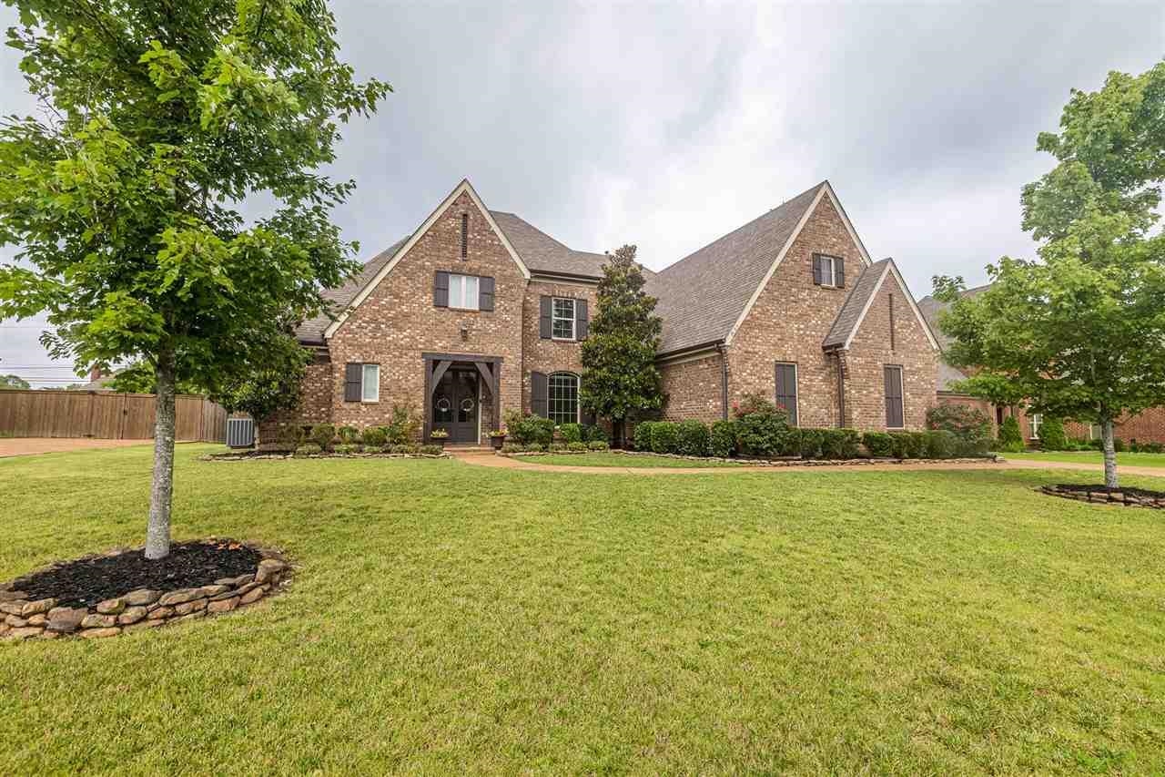 View of front of property with brick siding and roof with shingles