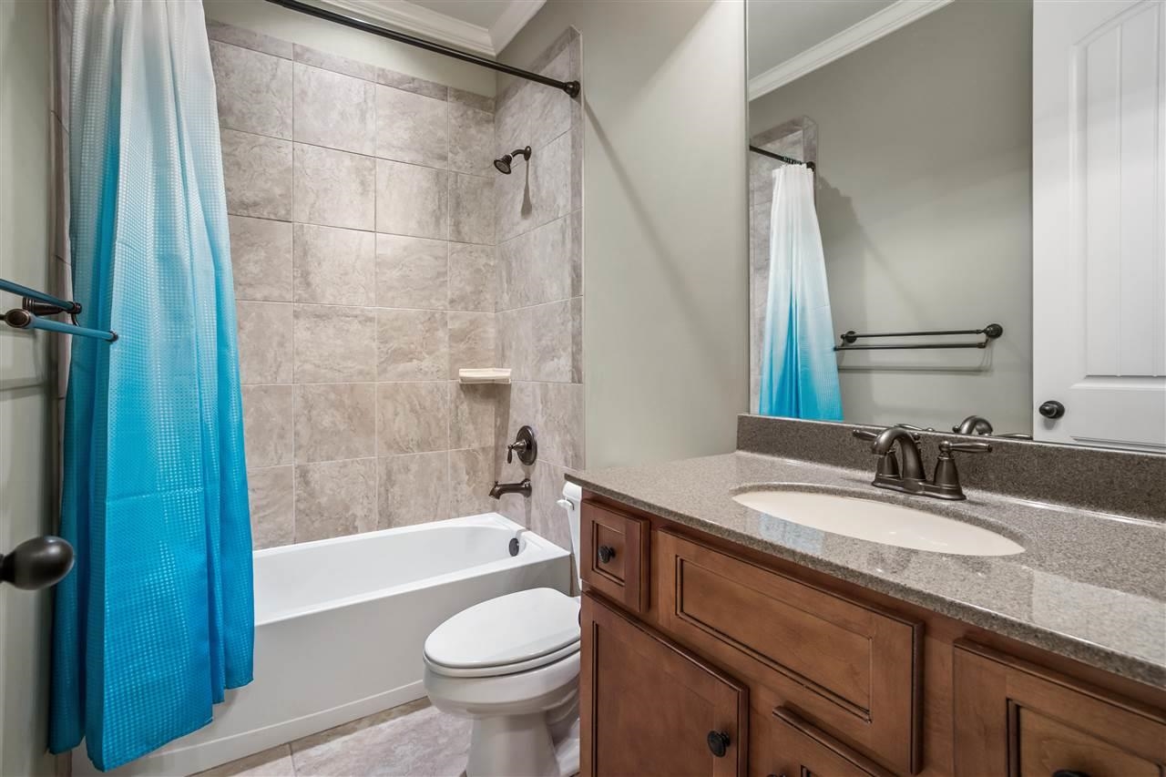 1357 Carmony Street Collierville, TN 38017 - Photo 11 of 16 Bathroom with vanity, shower / tub combo with curtain, and ornamental molding