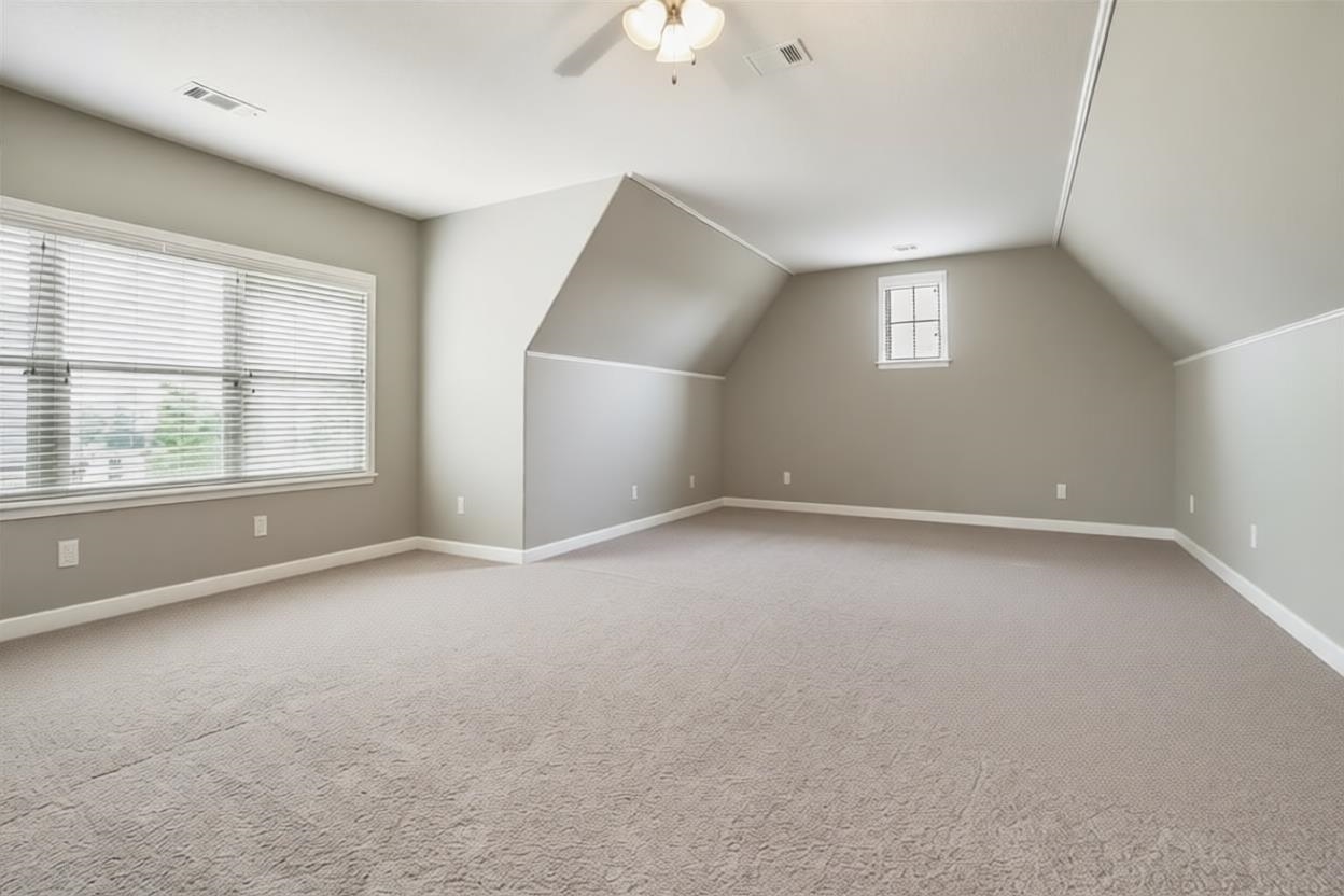 1357 Carmony Street Collierville, TN 38017 - Photo 12 of 16 Additional living space featuring light colored carpet, lofted ceiling, and ceiling fan
