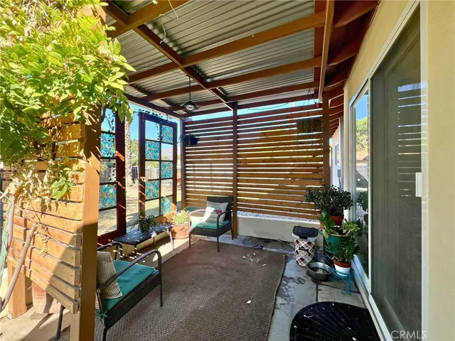 a view of backyard with outdoor seating and plants