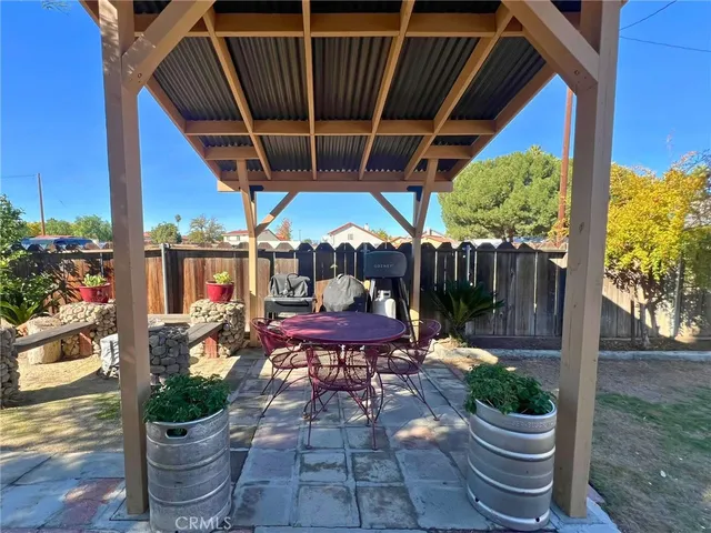 a view of a patio with table and chairs potted plants