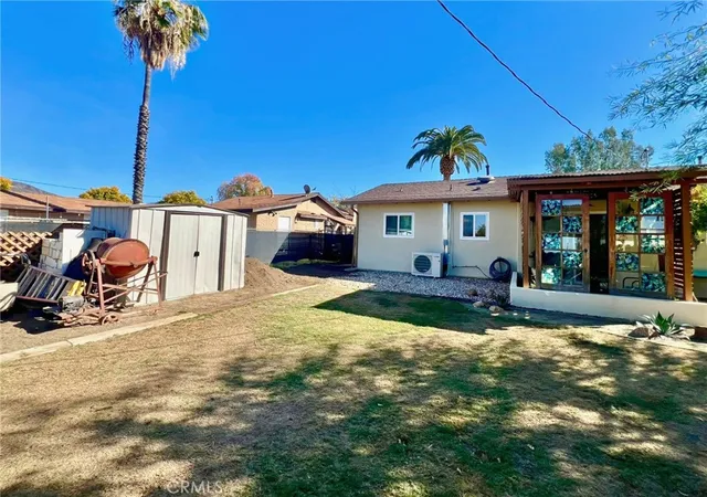 a view of a house with backyard porch and sitting area