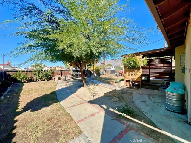 a view of a backyard with sitting area