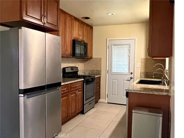 a kitchen with a refrigerator stove and microwave