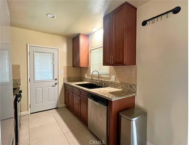 a kitchen with a sink stove and cabinets