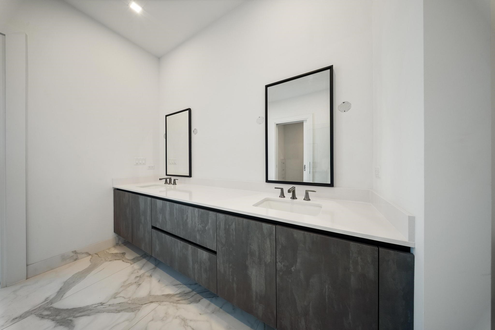 1711 Allen Parkway, Unit 1802 Houston, TX 77019 - Photo 14 of 28 a bathroom with a double vanity sink and mirror