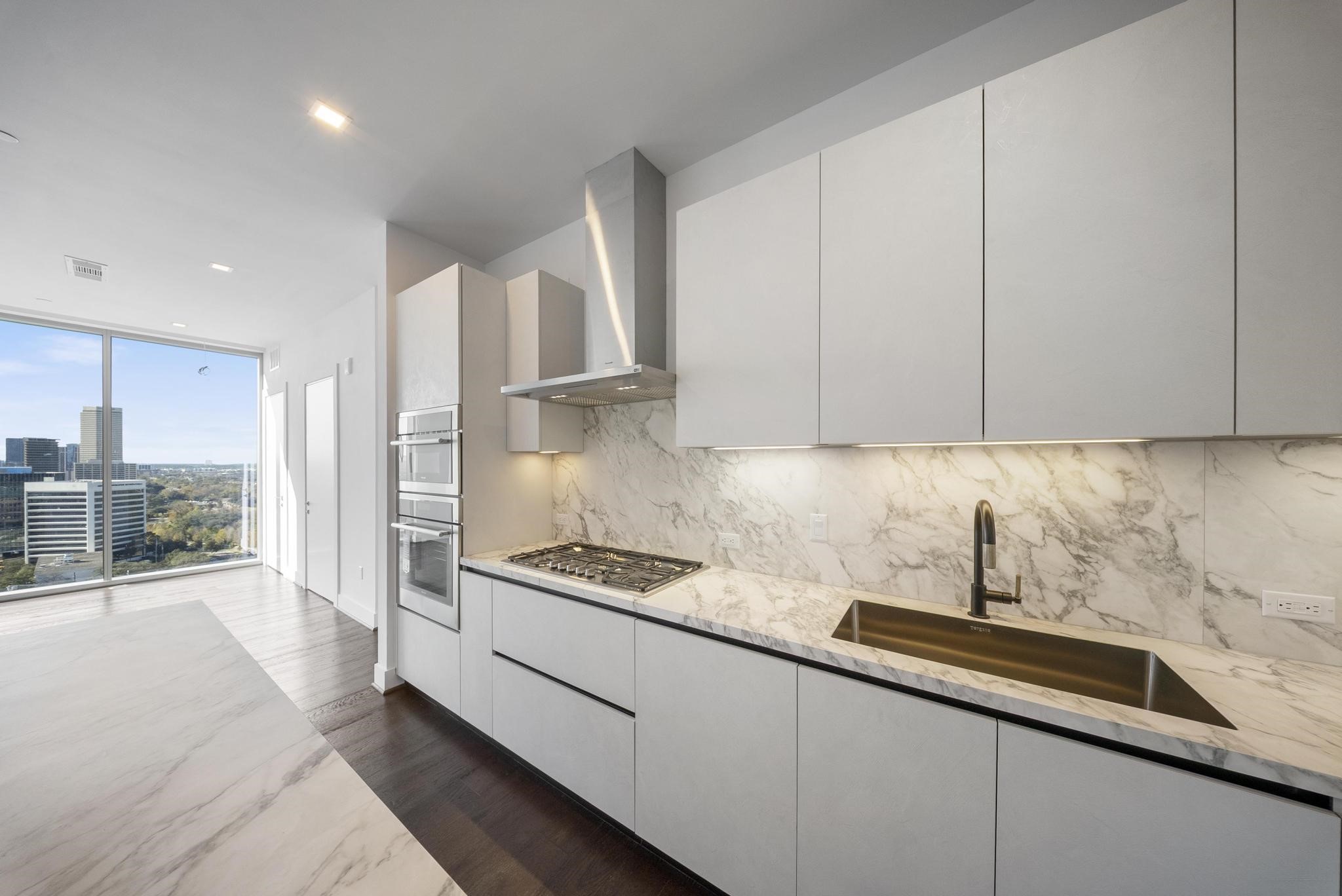 1711 Allen Parkway, Unit 1802 Houston, TX 77019 - Photo 3 of 28 a kitchen with stainless steel appliances granite countertop a sink and a white cabinets