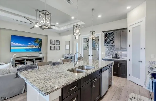 a kitchen with granite countertop a sink stainless steel appliances and counter space