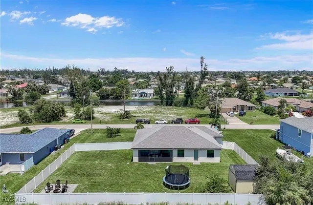 an aerial view of a house with yard swimming pool and outdoor seating