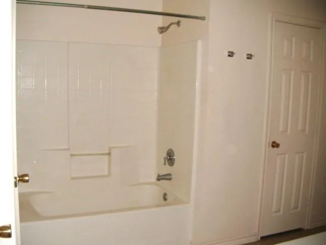 a close up of a bathtub with a shower