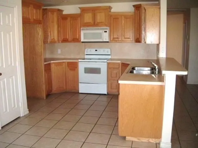 a kitchen with a stove a sink and a refrigerator