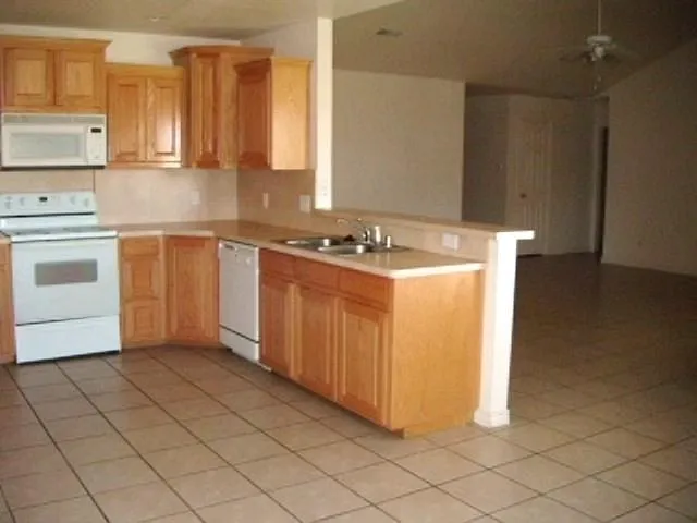 a kitchen with stainless steel appliances a stove a sink and a refrigerator