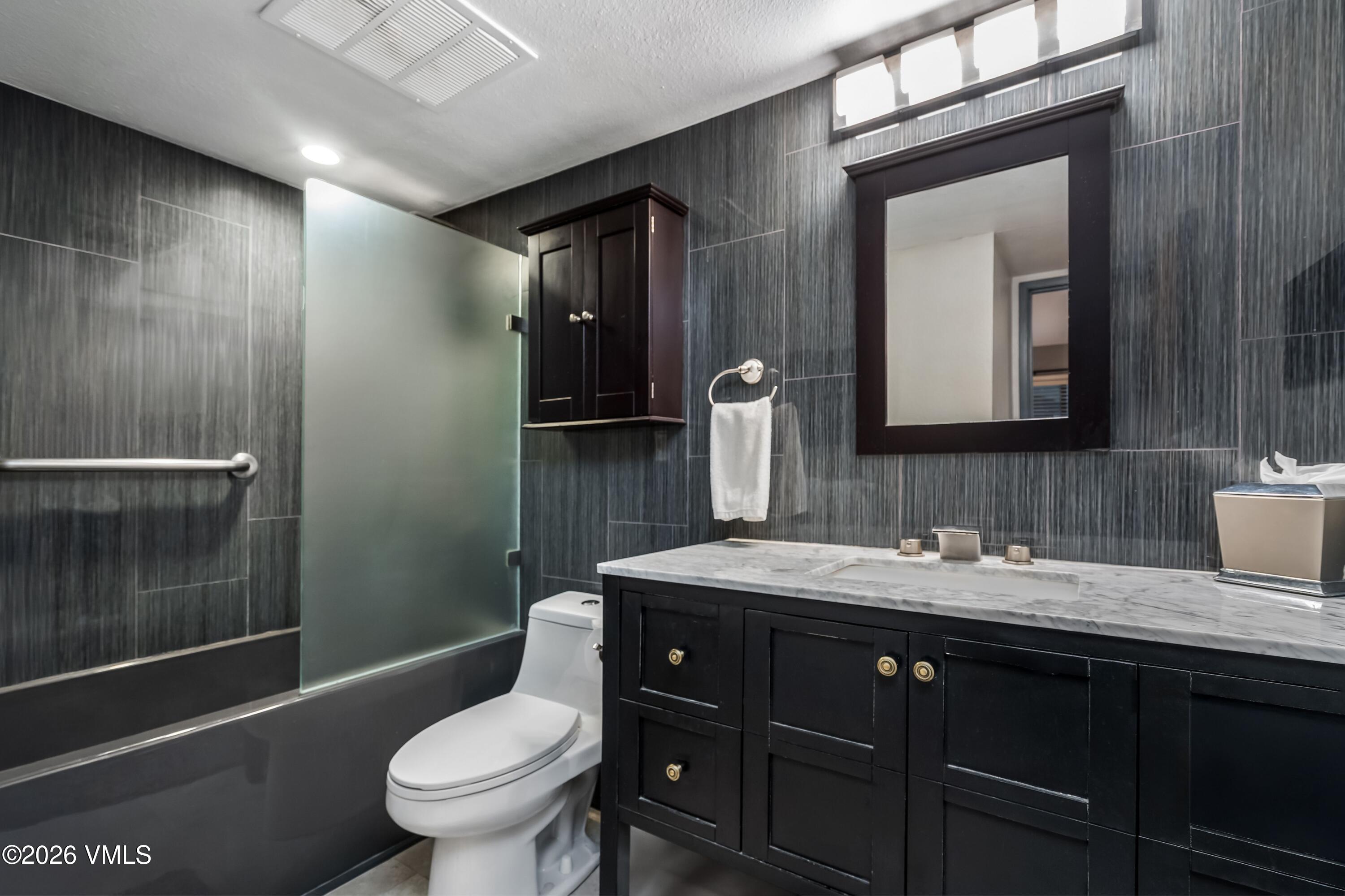 500 South Frontage Road East, Unit 308 Vail, CO 81657 - Photo 14 of 25 a bathroom with a toilet a sink and mirror