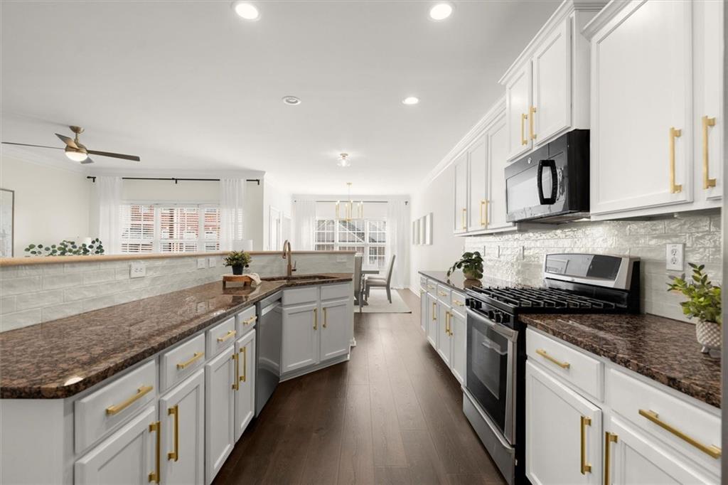 3196 Buck Way Alpharetta, GA 30004 - Photo 13 of 53 a large kitchen with stainless steel appliances granite countertop a sink stove and cabinets