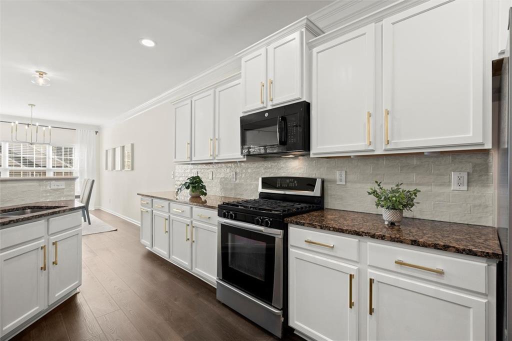 3196 Buck Way Alpharetta, GA 30004 - Photo 15 of 53 a kitchen with granite countertop white cabinets and white appliances