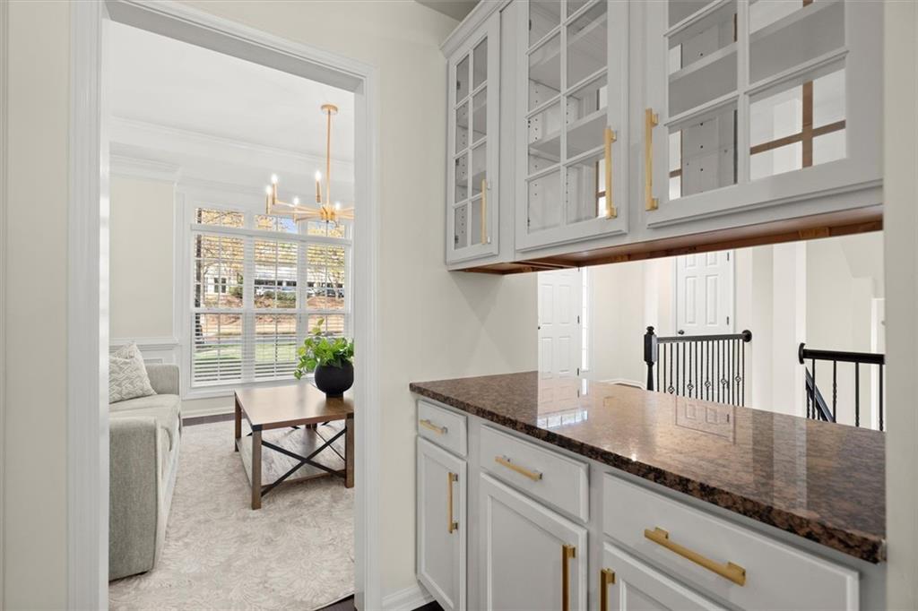3196 Buck Way Alpharetta, GA 30004 - Photo 16 of 53 a kitchen with granite countertop a sink and white cabinets
