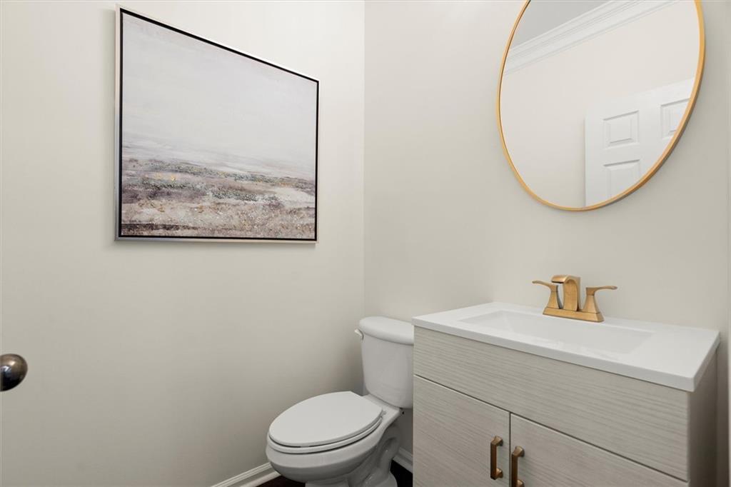 3196 Buck Way Alpharetta, GA 30004 - Photo 17 of 53 a bathroom with a toilet a sink and a mirror