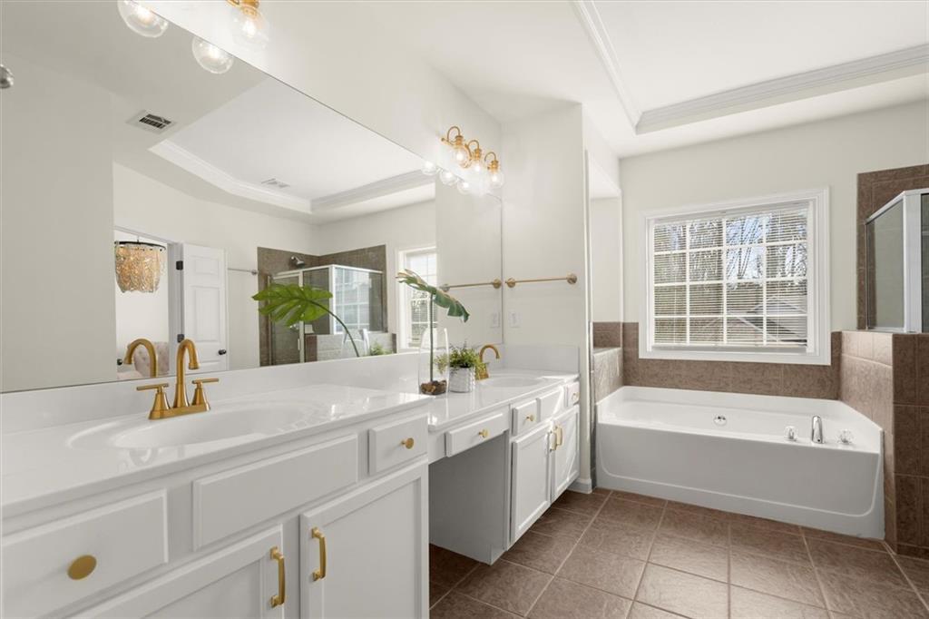 3196 Buck Way Alpharetta, GA 30004 - Photo 39 of 53 a bathroom with a bathtub a sink and a window
