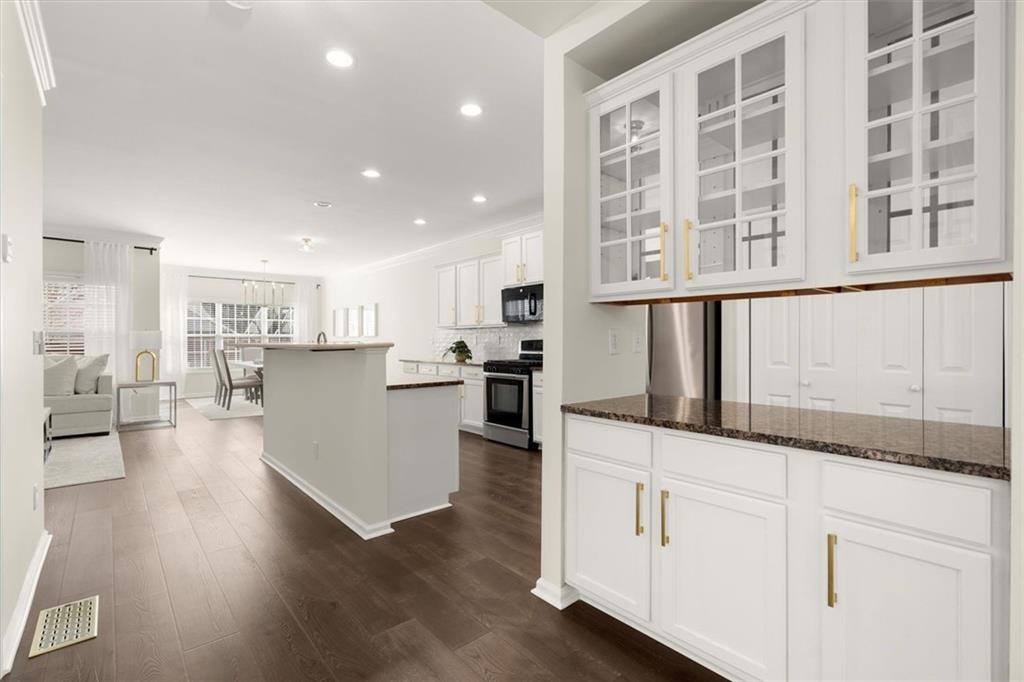 3196 Buck Way Alpharetta, GA 30004 - Photo 9 of 53 a kitchen with granite countertop white cabinets and refrigerator