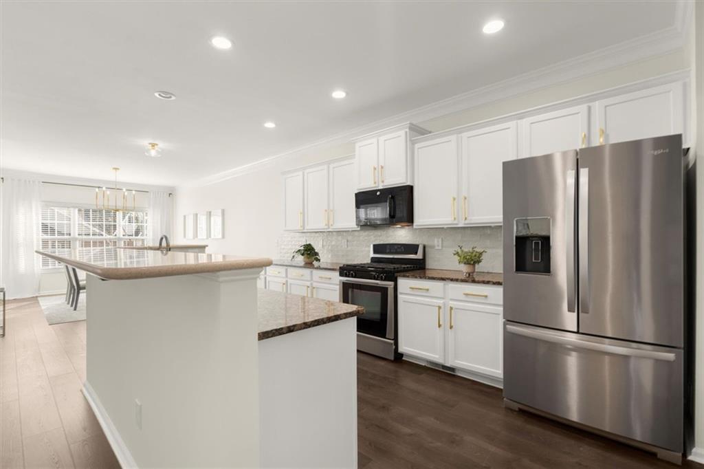 3196 Buck Way Alpharetta, GA 30004 - Photo 10 of 53 a kitchen with white cabinets and stainless steel appliances