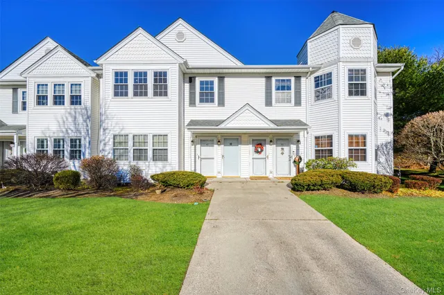 a front view of a house with a yard and porch