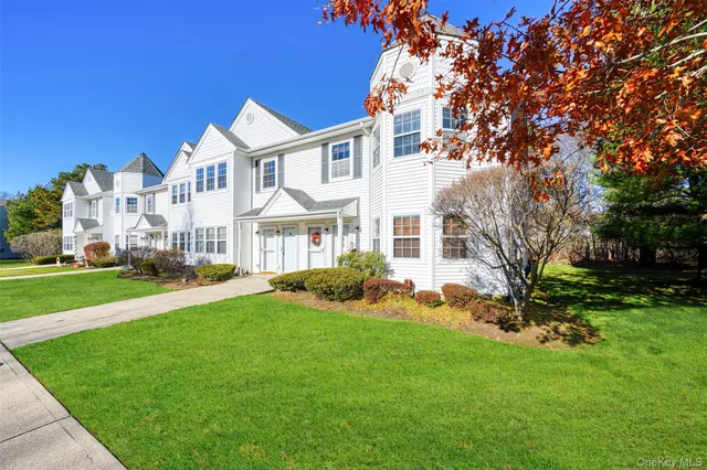 a front view of a house with a yard table and chairs