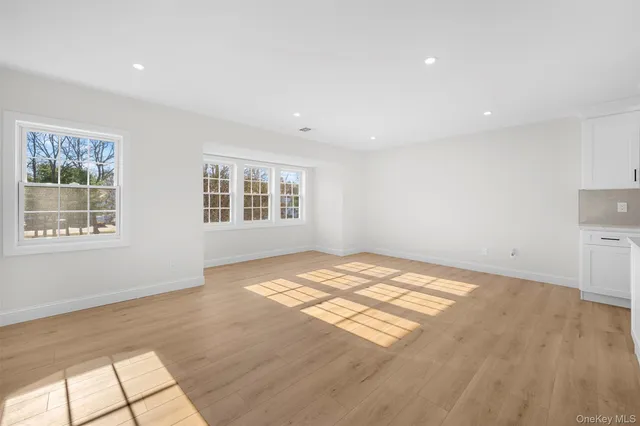 a view of kitchen with refrigerator sink and cabinets